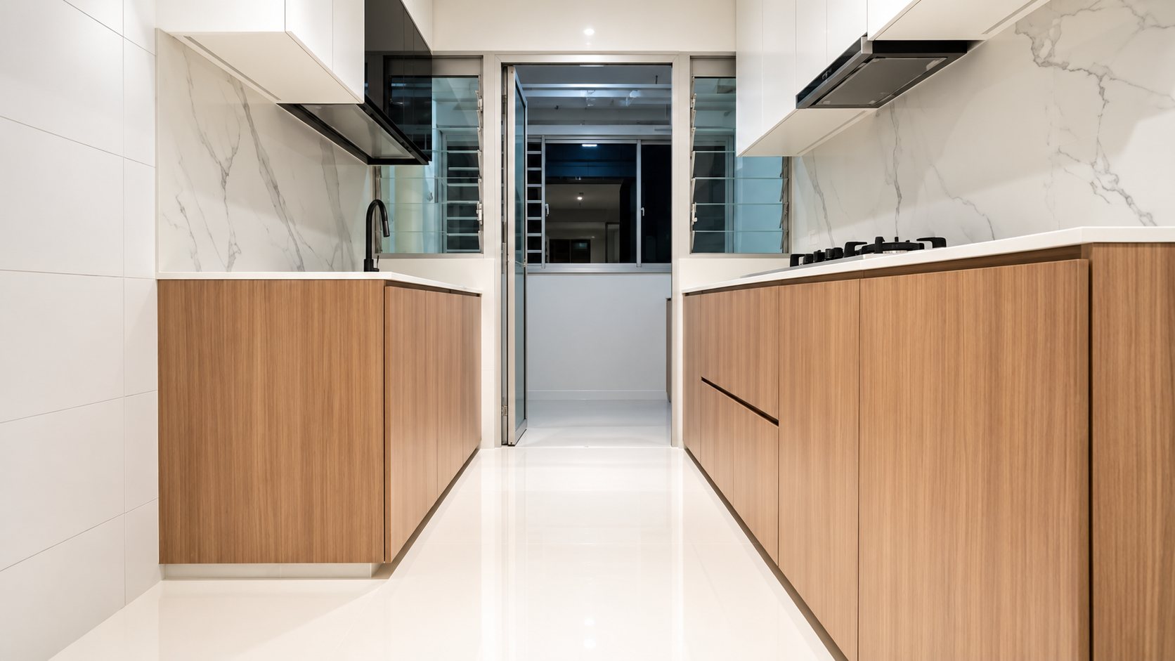 Modern galley kitchen with seamless light microcement-style floor and wood cabinetry